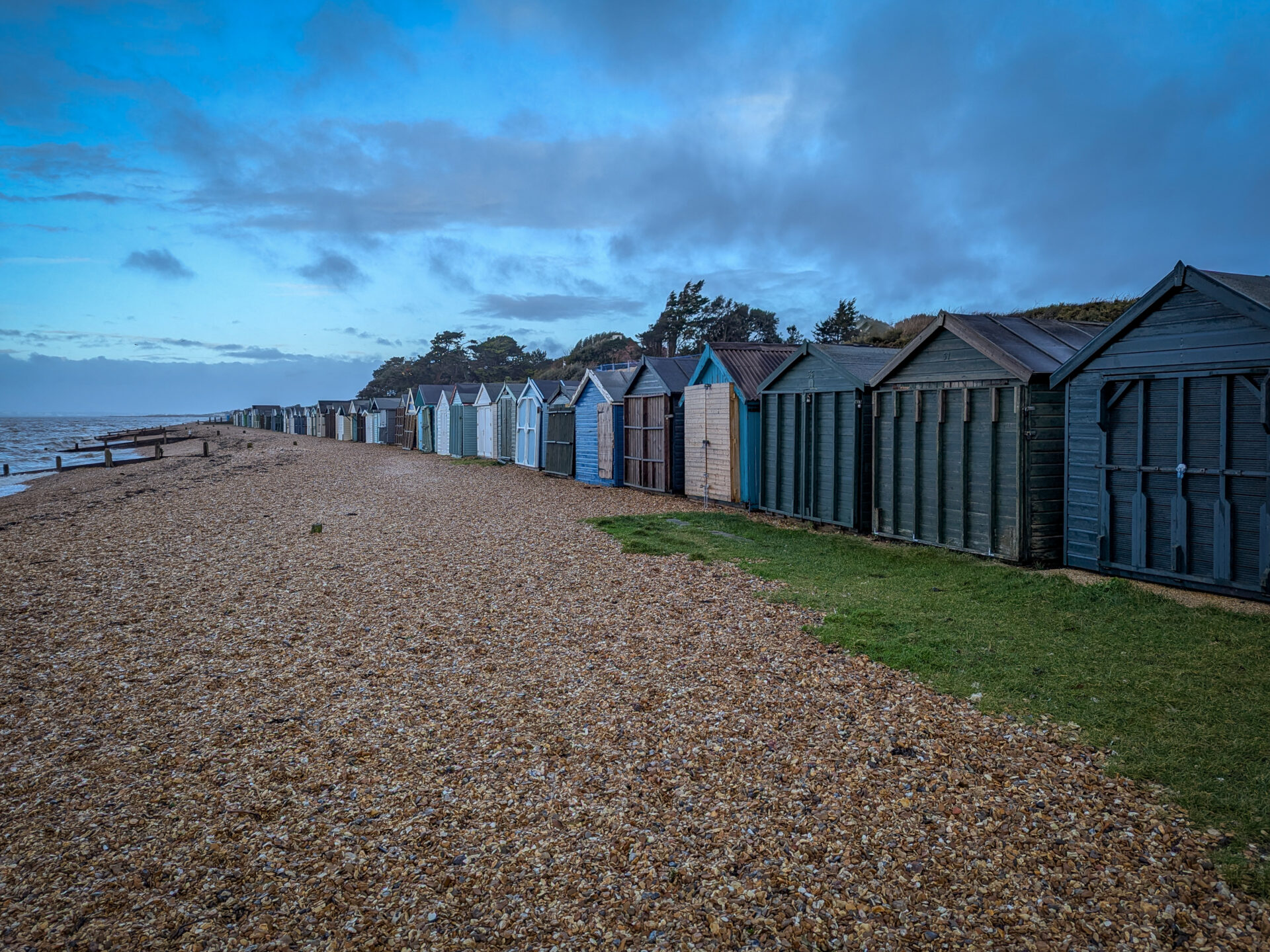 A black and white marina scene capturing boats at rest with soft reflections, focusing on calm, balance, and atmosphere.