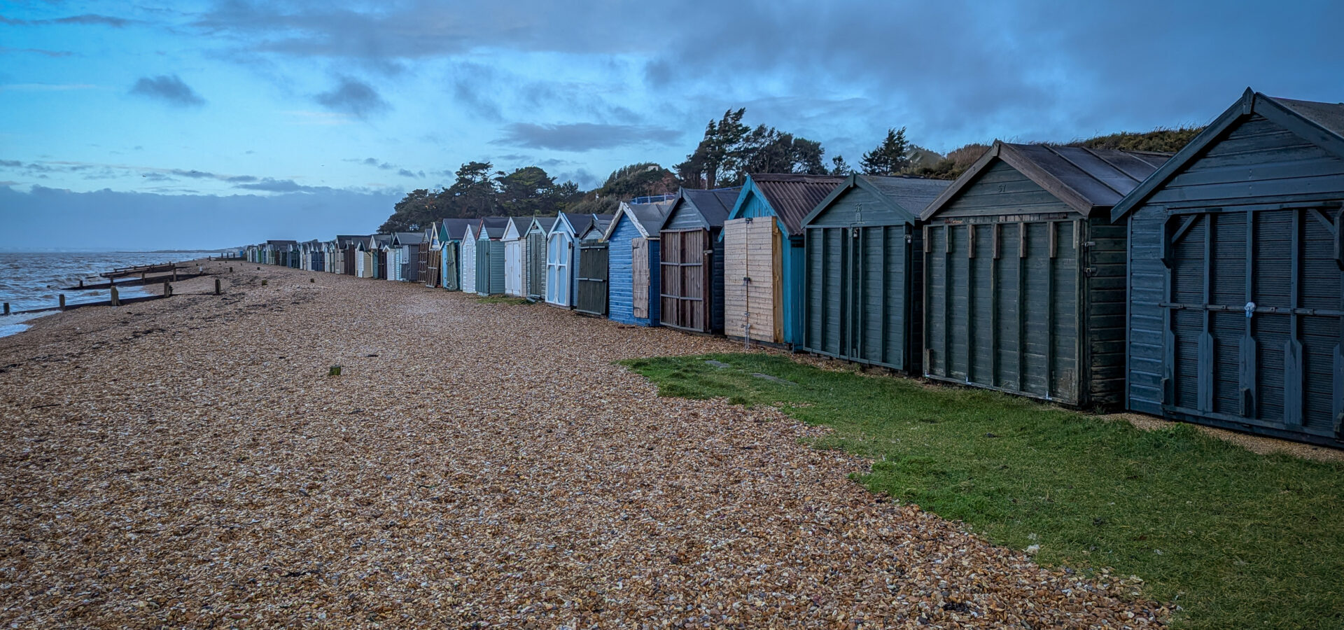 A black and white marina scene capturing boats at rest with soft reflections, focusing on calm, balance, and atmosphere.